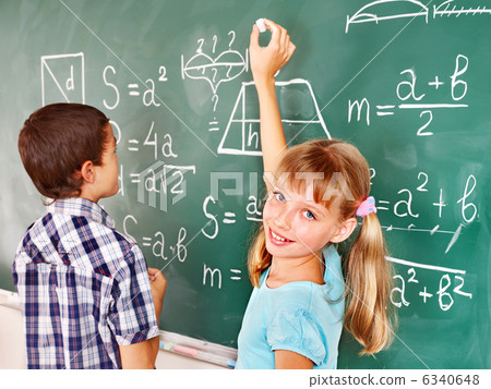 School child writting on blackboard. School child writting on blackboard. 6340648