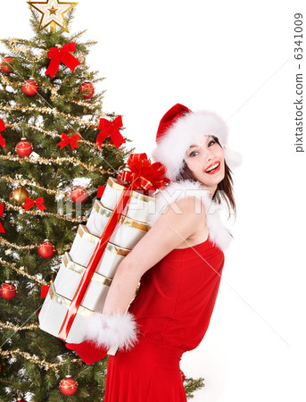 Christmas girl in santa hat holding stack gift box. 6341009