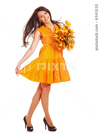 Woman holding orange leaves. 6341010