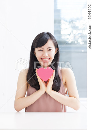 A woman with a pink heart A woman with a pink heart 6344402