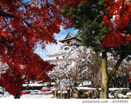 Inuyama castle with snow and autumn leaves 6344690