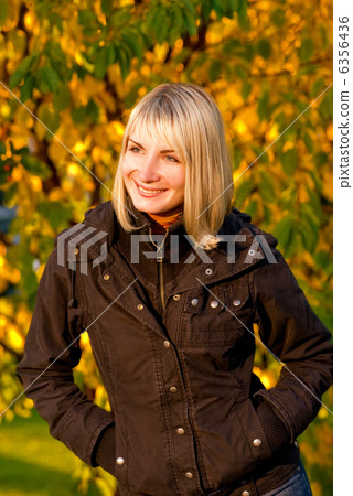 Cute smiling girl on autumn background 6356436