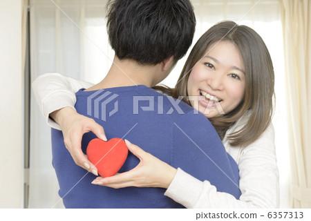 A young woman embracing men A young woman embracing men 6357313