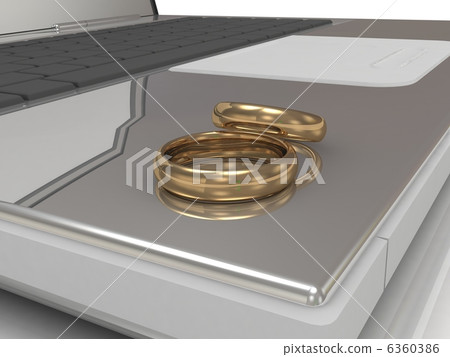 Two wedding rings on a laptop Two wedding rings on a laptop 6360386