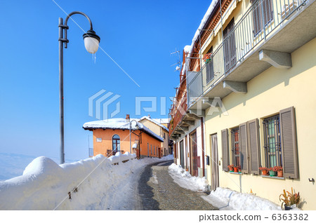 Narrow snowy street in small town. Diano DAlba, Italy. 6363382