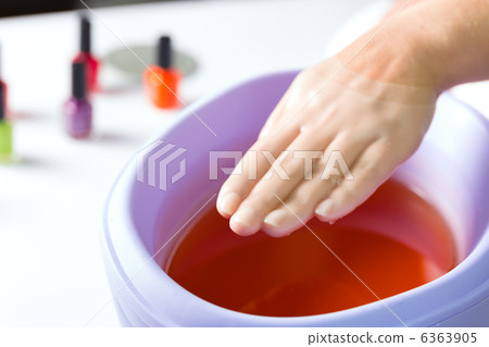 Woman in nail salon having paraffin bath 6363905