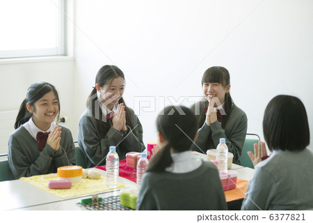 Junior high school students holding their lunch in front 6377821