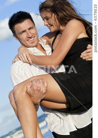 Romantic Couple On Beach With The Man Carrying his Woman Romantic Couple On Beach With The Man Carrying his Woman 6379810