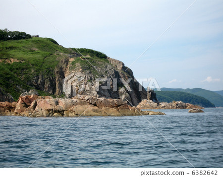 Rocks in the blue sea, illuminated by the sun. Background. 6382642