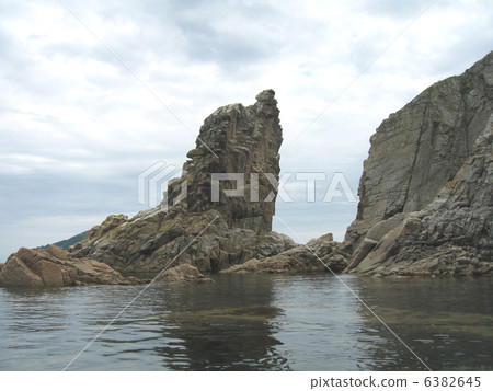 Rocks in the blue sea, illuminated by the sun. Background. Rocks in the blue sea, illuminated by the sun. Background. 6382645