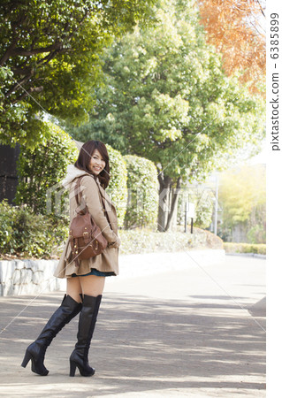 Women in coat and knee high boots 6385899