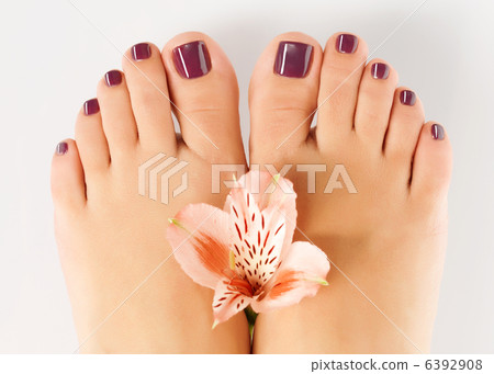 female feet with beautiful pedicure after spa procedure 6392908