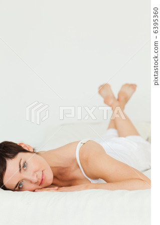 Portrait of a cute woman lying on her belly 6395360