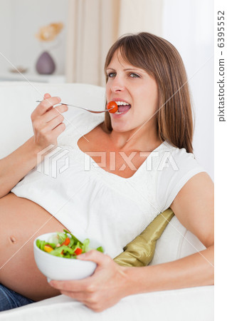 Close up of a mother to be eating a salad Close up of a mother to be eating a salad 6395552