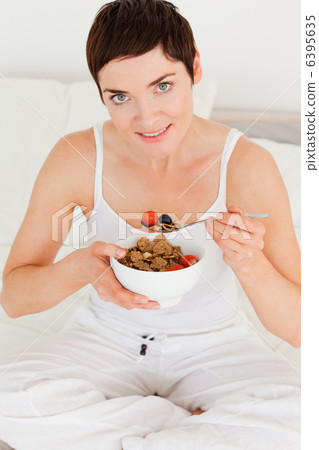 Lovely woman eating breakfast 6395635