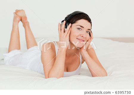 Cute brunette listening to music 6395730