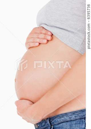 Side view of a pregnant woman caressing her belly while standing Side view of a pregnant woman caressing her belly while standing 6395736