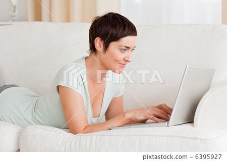 Happy short-haired woman using a laptop Happy short-haired woman using a laptop 6395927
