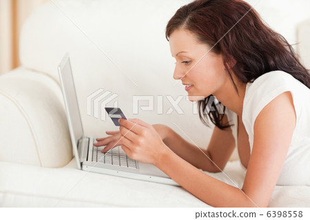 Dark-haired woman doing some online shopping Dark-haired woman doing some online shopping 6398558