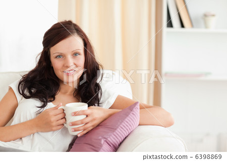 Portrait of a woman holding a cup 6398869