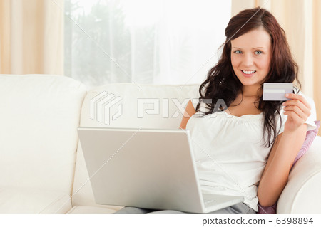 Gorgeous red-haired doing online shopping Gorgeous red-haired doing online shopping 6398894