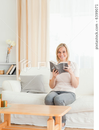 Portrait of a blond-haired woman with a book Portrait of a blond-haired woman with a book 6399071