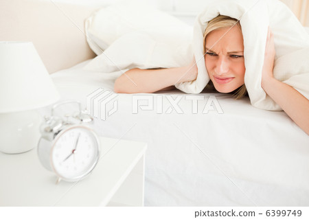 Displeased young woman waking up 6399749