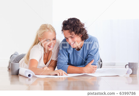 Smiling couple getting ready to move in a new house Smiling couple getting ready to move in a new house 6399786