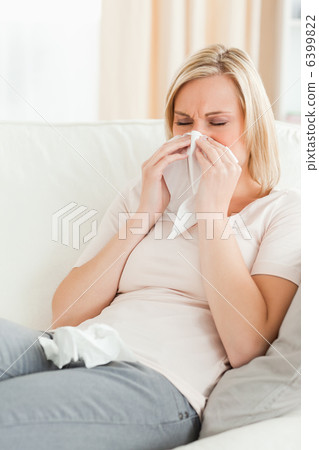 Portrait of a woman blowing her nose Portrait of a woman blowing her nose 6399822