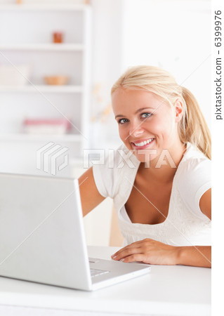 Portrait of a cute woman with a laptop 6399976