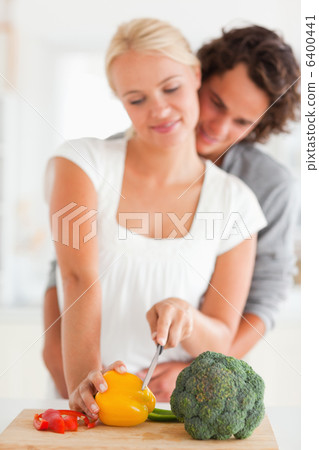 Portrait of a young couple slicing pepper 6400441