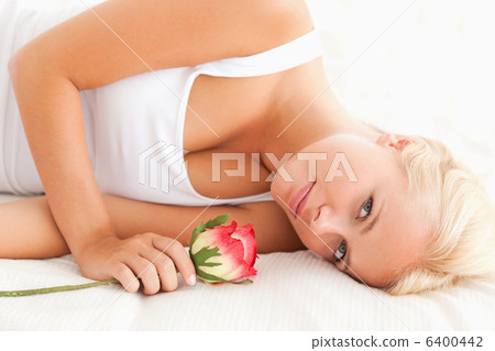 Close up of a quiet woman with a flower 6400442