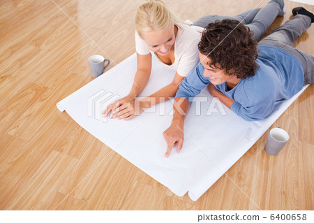 Man showing a point on a plan to his girlfriend Man showing a point on a plan to his girlfriend 6400658