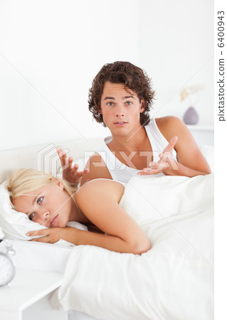Portrait of an upset man arguing with his fiance 6400943