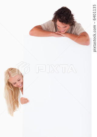 Man and woman looking at a whiteboard 6401135