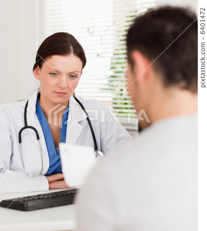 Female doctor and a patient reading prescription 6401472