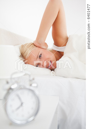 Portrait of an alarmclock waking up a woman Portrait of an alarmclock waking up a woman 6401477