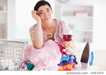 Sad Woman with wine and a pile of clothes 6401976