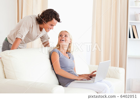 Laughing couple with a laptop 6402051