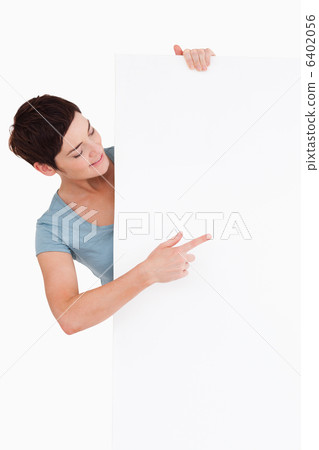 Smiling brunette looking at a blank panel Smiling brunette looking at a blank panel 6402056