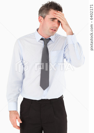 Portrait of a sad businessman with his hand on his forehead Portrait of a sad businessman with his hand on his forehead 6402171
