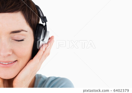 Close up of a delighted woman enjoying some music Close up of a delighted woman enjoying some music 6402379