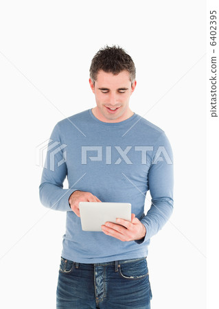 Portrait of a man using a tablet computer Portrait of a man using a tablet computer 6402395