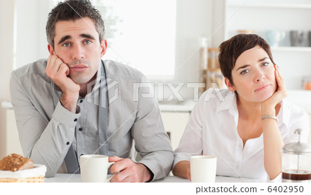 Worn out couple drinking coffee 6402950