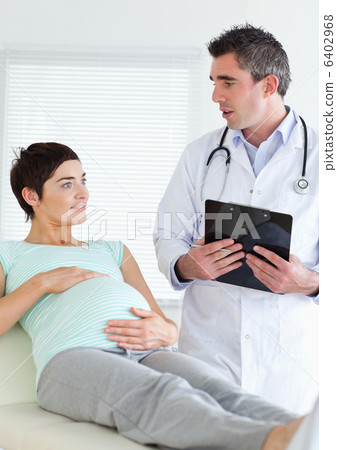 Doctor talking to a pregnant woman 6402968