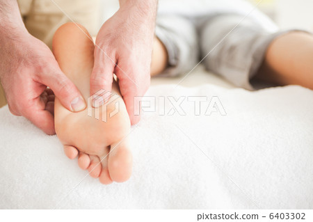 Male masseur massaging a womans foot 6403302