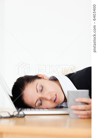 Beautiful businesswoman sleeping in office 6403400