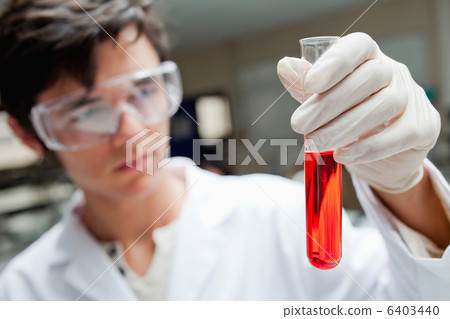 Young scientist holding a test tube Young scientist holding a test tube 6403440