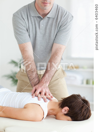 Handsome Man massaging a cute womans neck Handsome Man massaging a cute womans neck 6403460