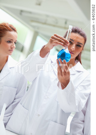 Portrait of scientists looking a flask 6403682